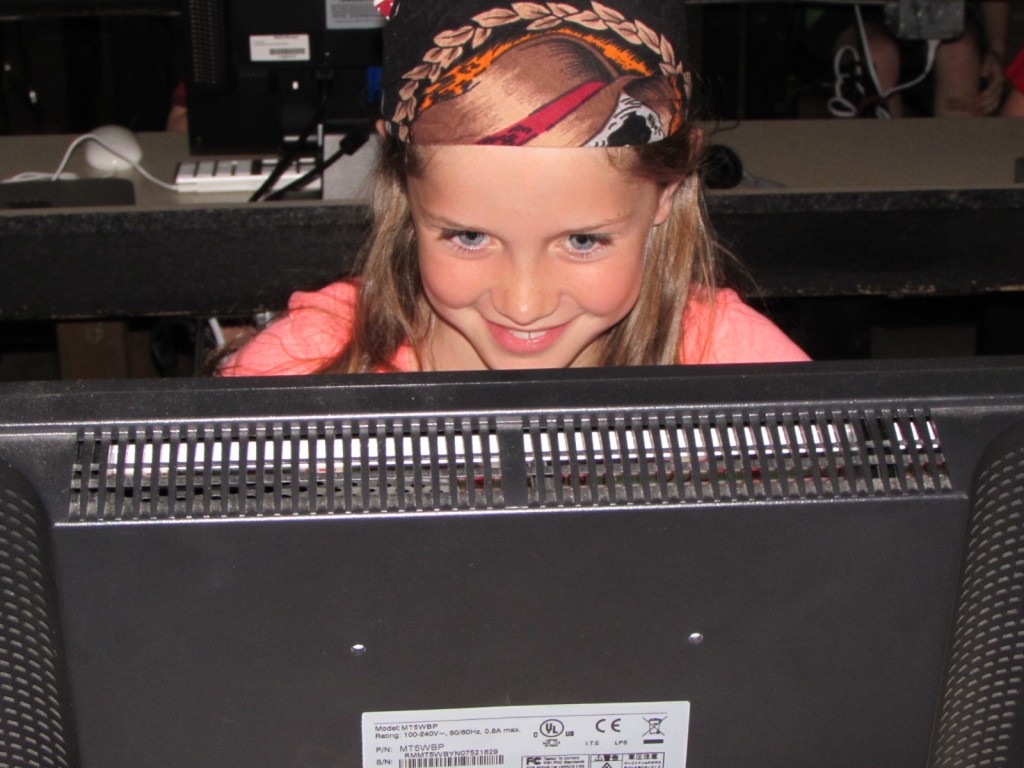 Photo of elementary student smiling at a computer screen